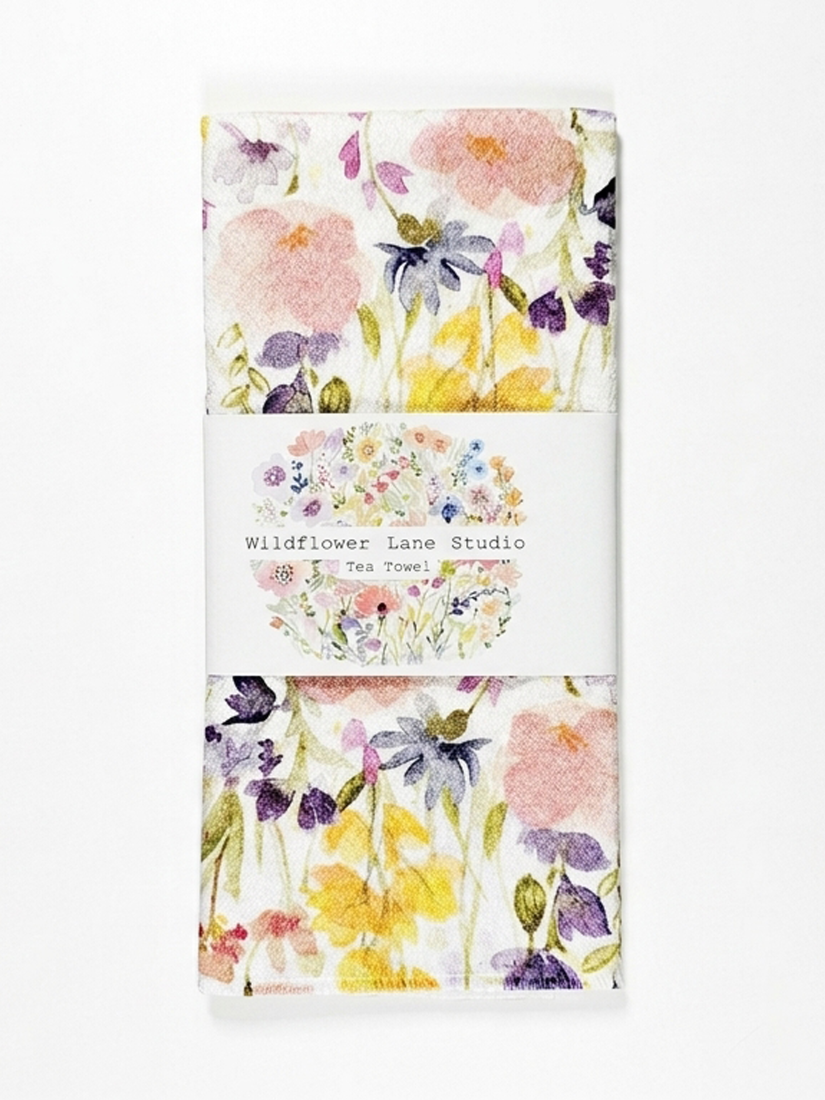 Tea towels with floral design and 'Wildflower Lane Studio' branding.