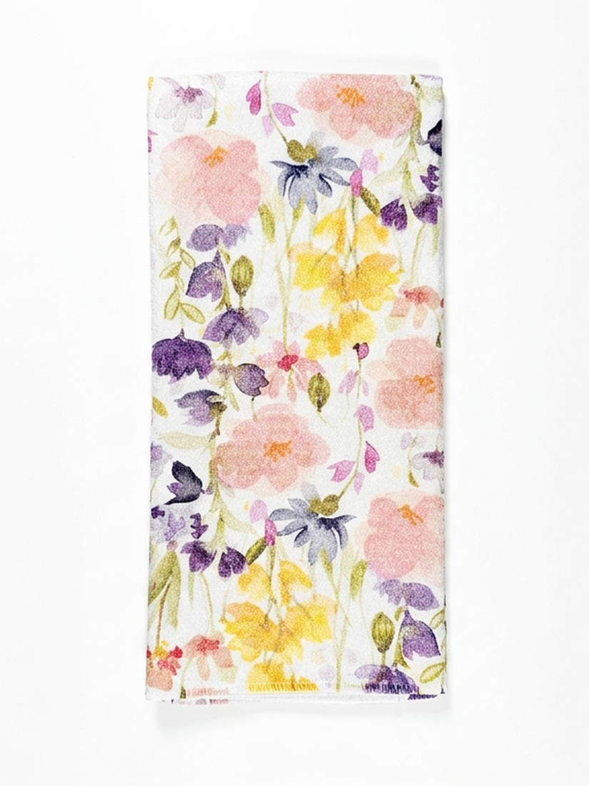 Floral patterned tea towel with colorful flowers on a white background
