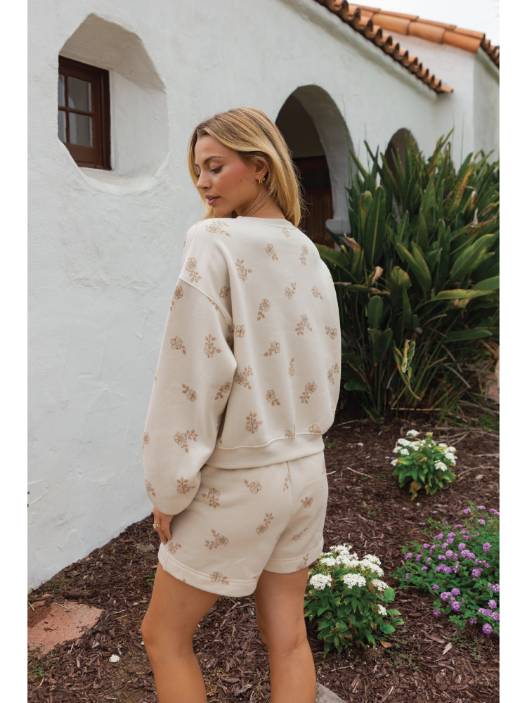 Cozy two-piece matching set in a soft-brushed fabric with a whimsical "Aloha" graphic and a relaxed, soulful coastal aesthetic.