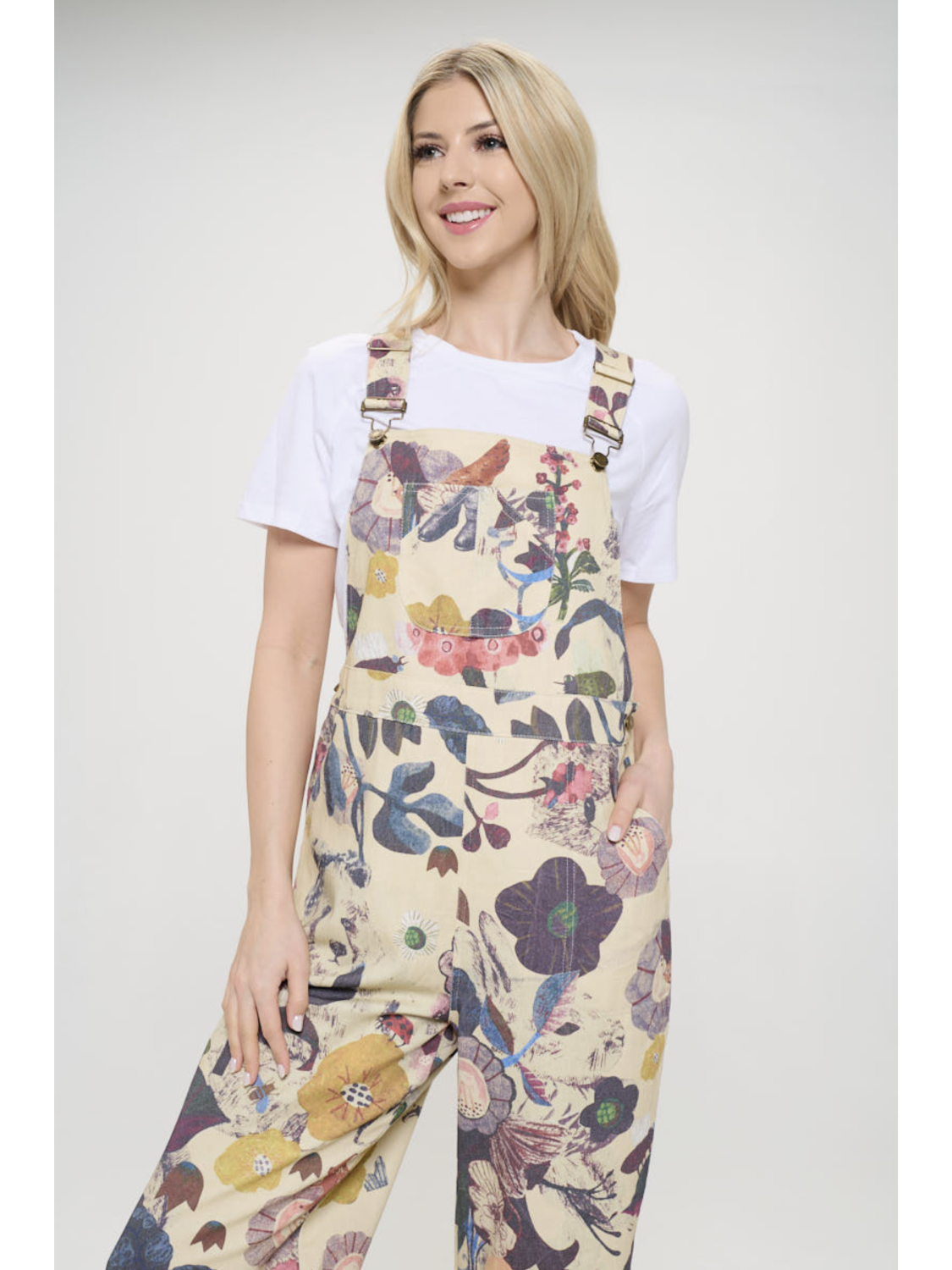 Woman wearing a floral overalls on a white background