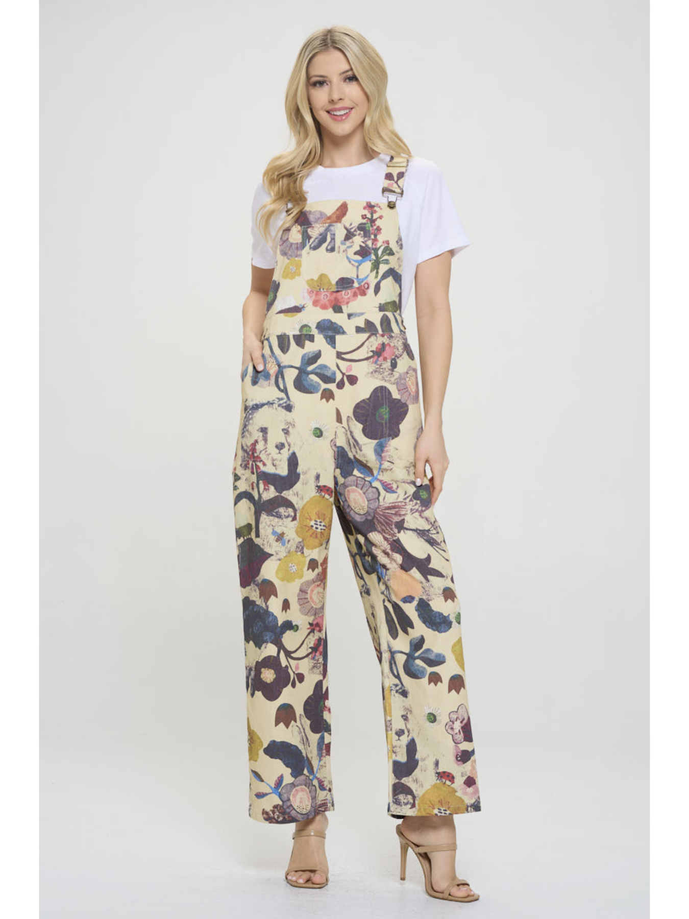 Woman wearing a floral jumpsuit on a white background