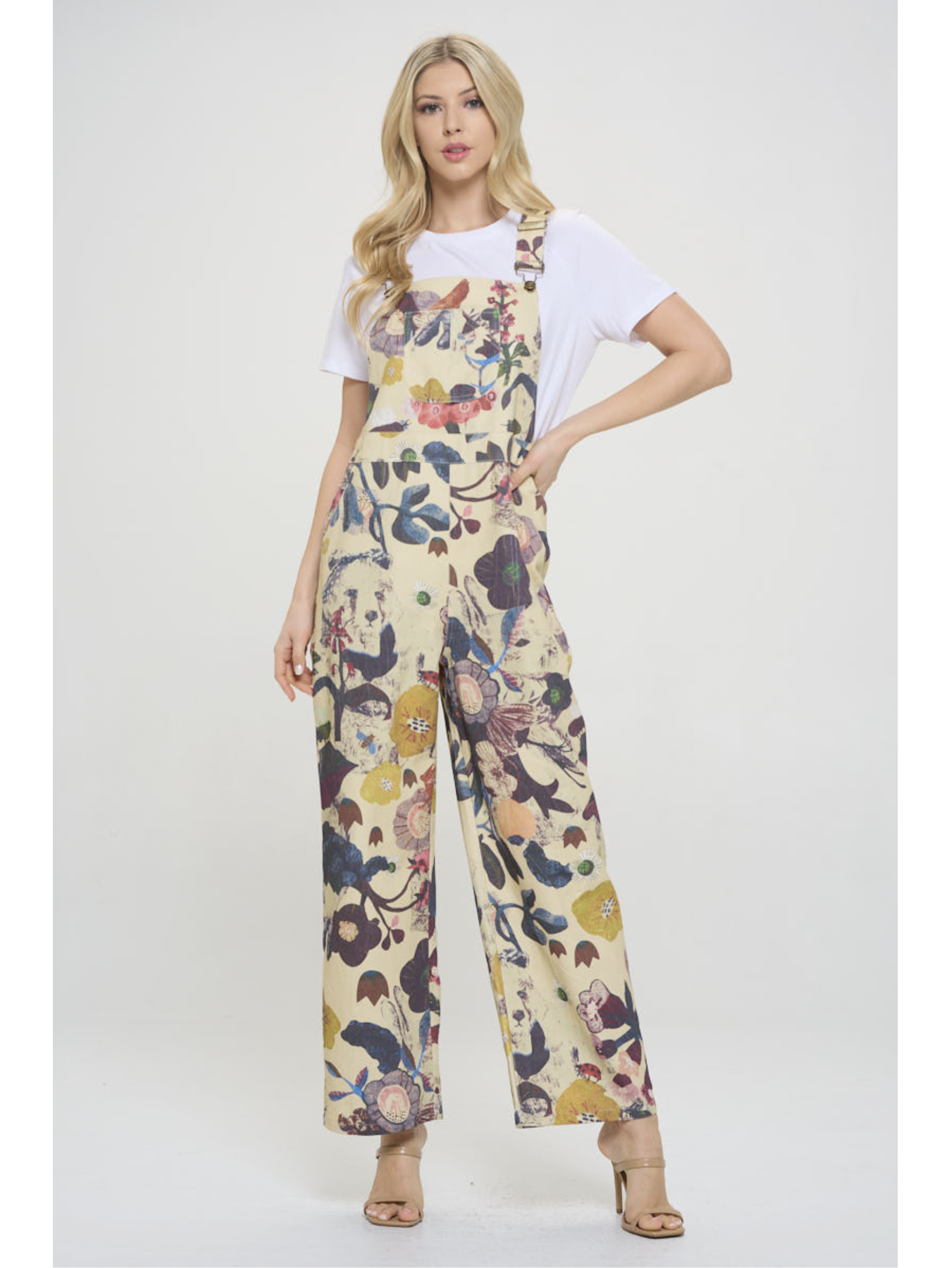 Woman wearing a floral jumpsuit on a white background