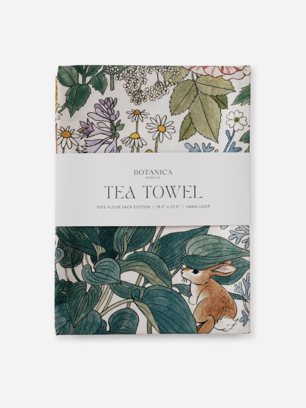 Tea towel packaging with botanical design and rabbit illustration on a white background