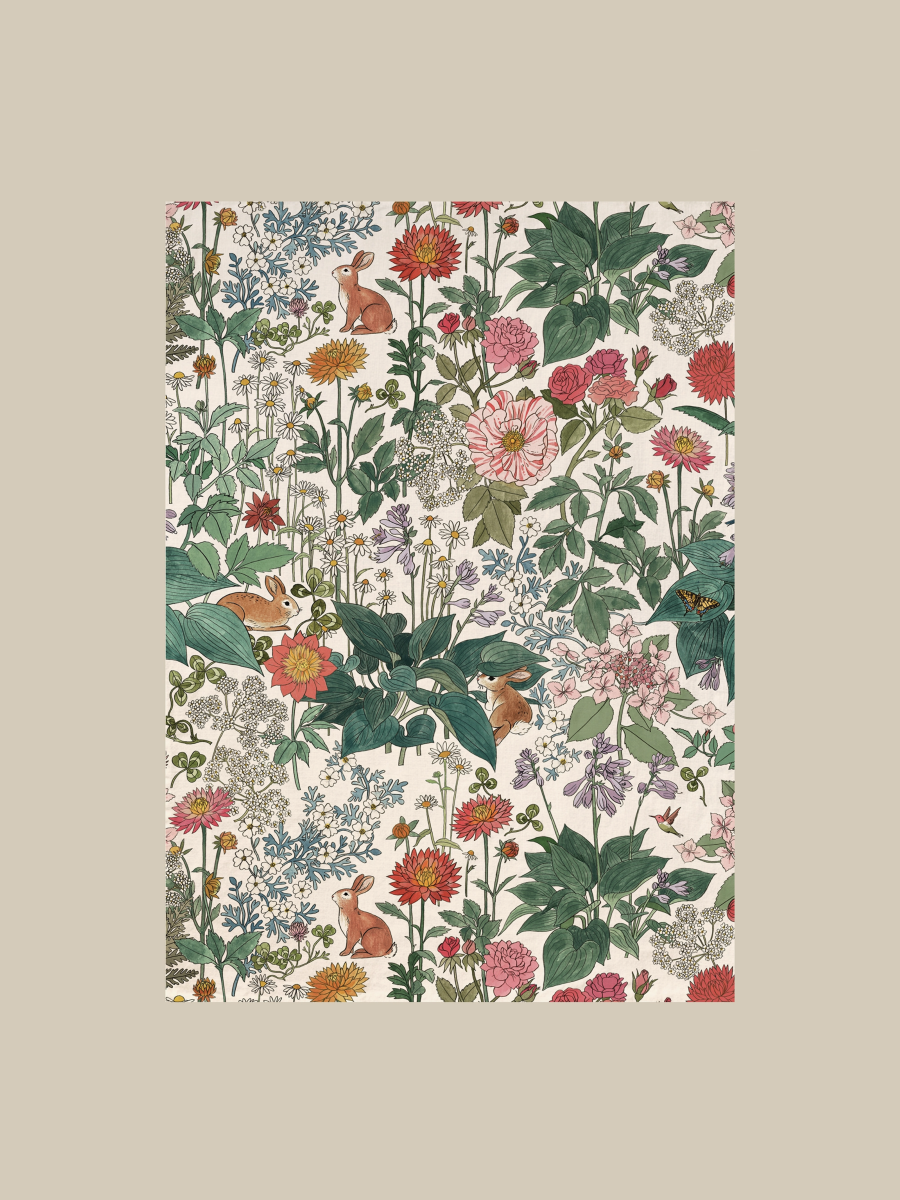Floral and animal patterned tea towel on a beige background