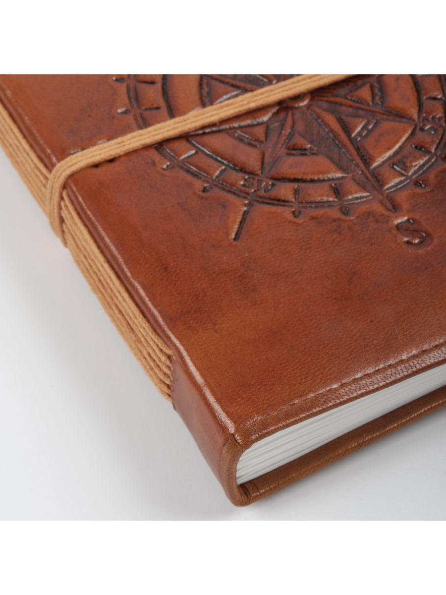 Brown leather notebook with embossed design on a white background