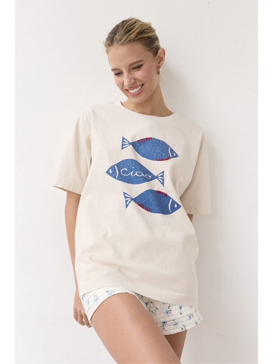 Artisanal t-shirt featuring a whimsical fish graphic with unique stitch details on a soft-wash fabric for a soulful, coastal, slow-living aesthetic