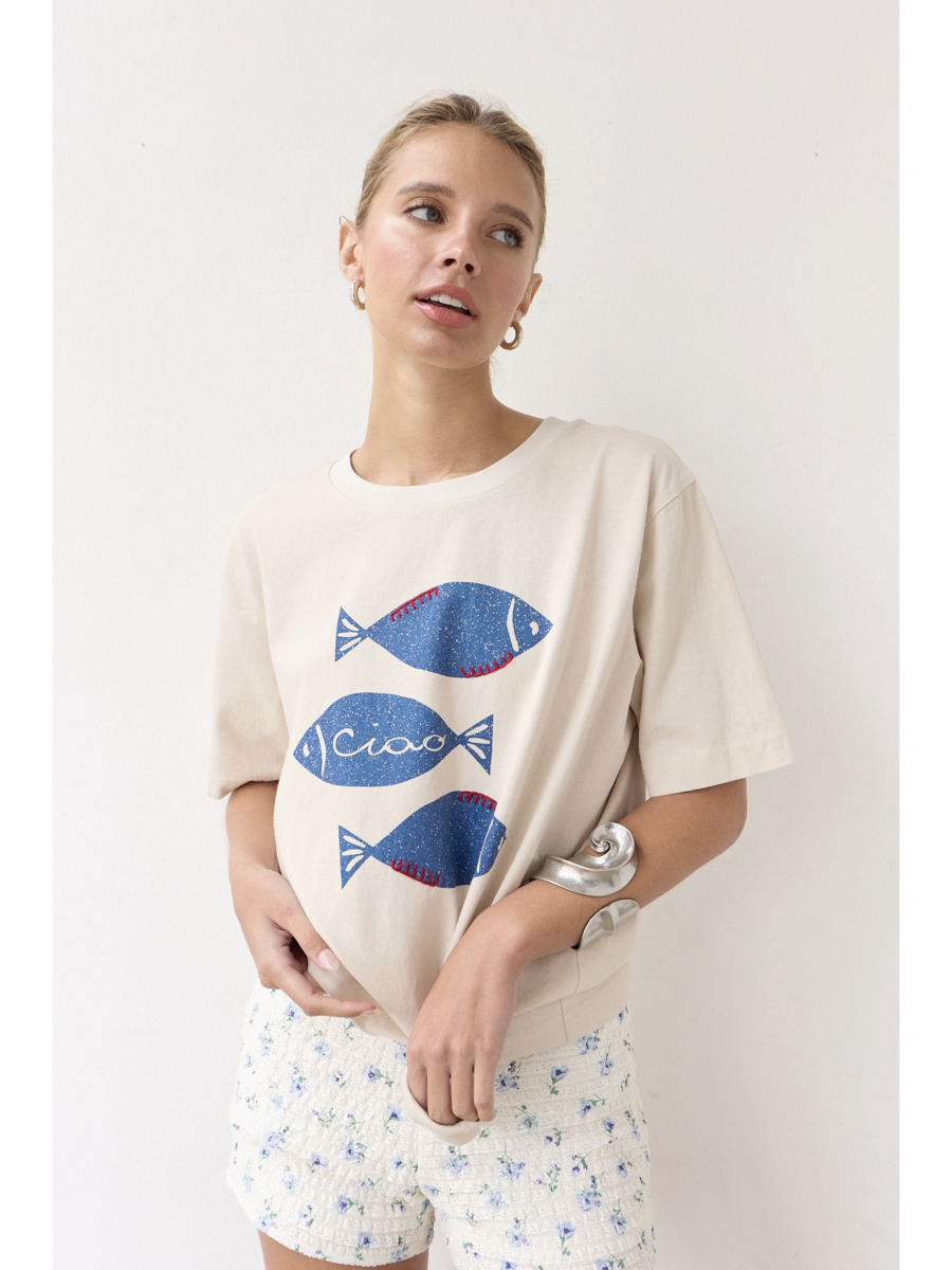 Artisanal t-shirt featuring a whimsical fish graphic with unique stitch details on a soft-wash fabric for a soulful, coastal, slow-living aesthetic