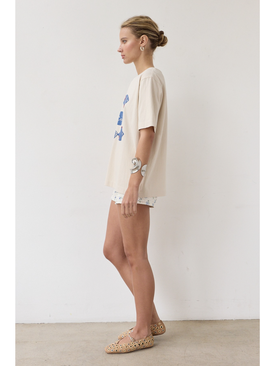Artisanal t-shirt featuring a whimsical fish graphic with unique stitch details on a soft-wash fabric for a soulful, coastal, slow-living aesthetic