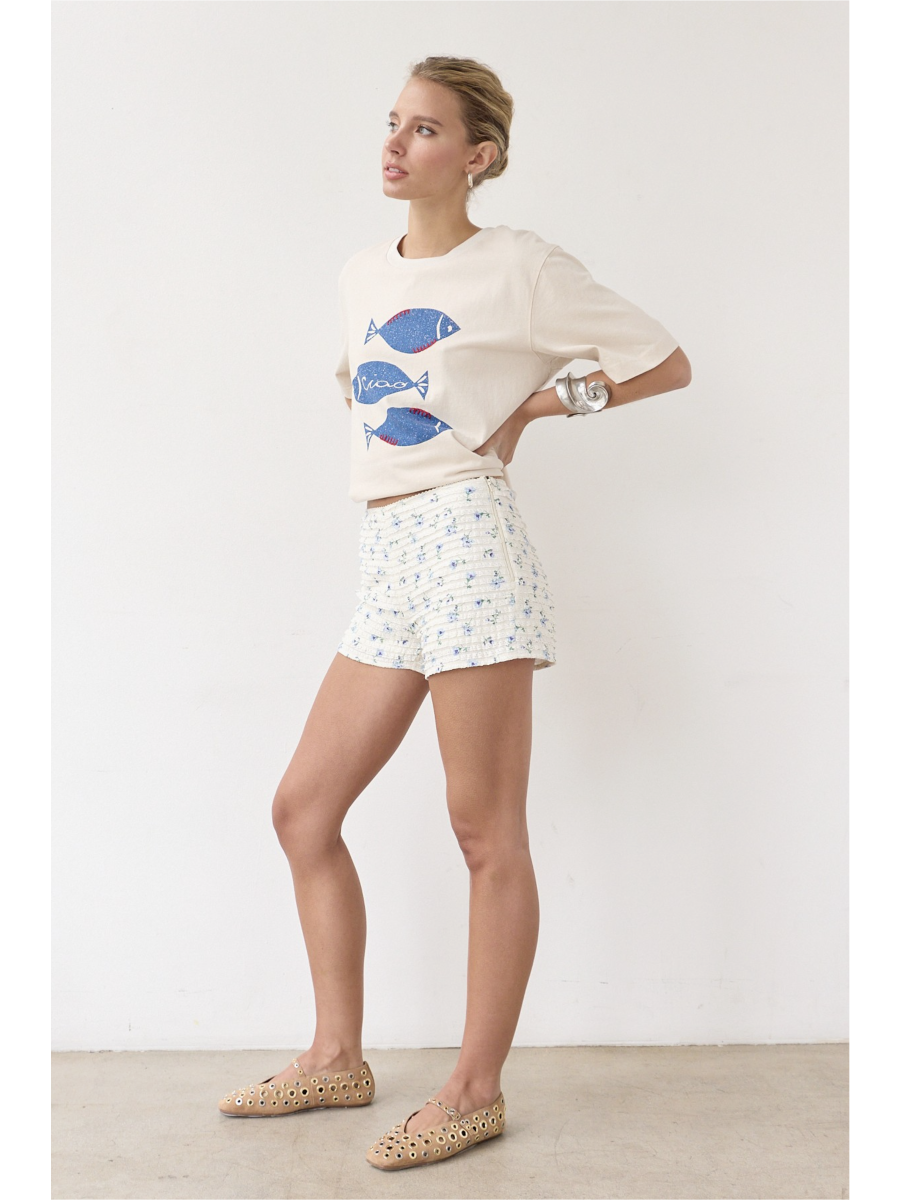 Artisanal t-shirt featuring a whimsical fish graphic with unique stitch details on a soft-wash fabric for a soulful, coastal, slow-living aesthetic