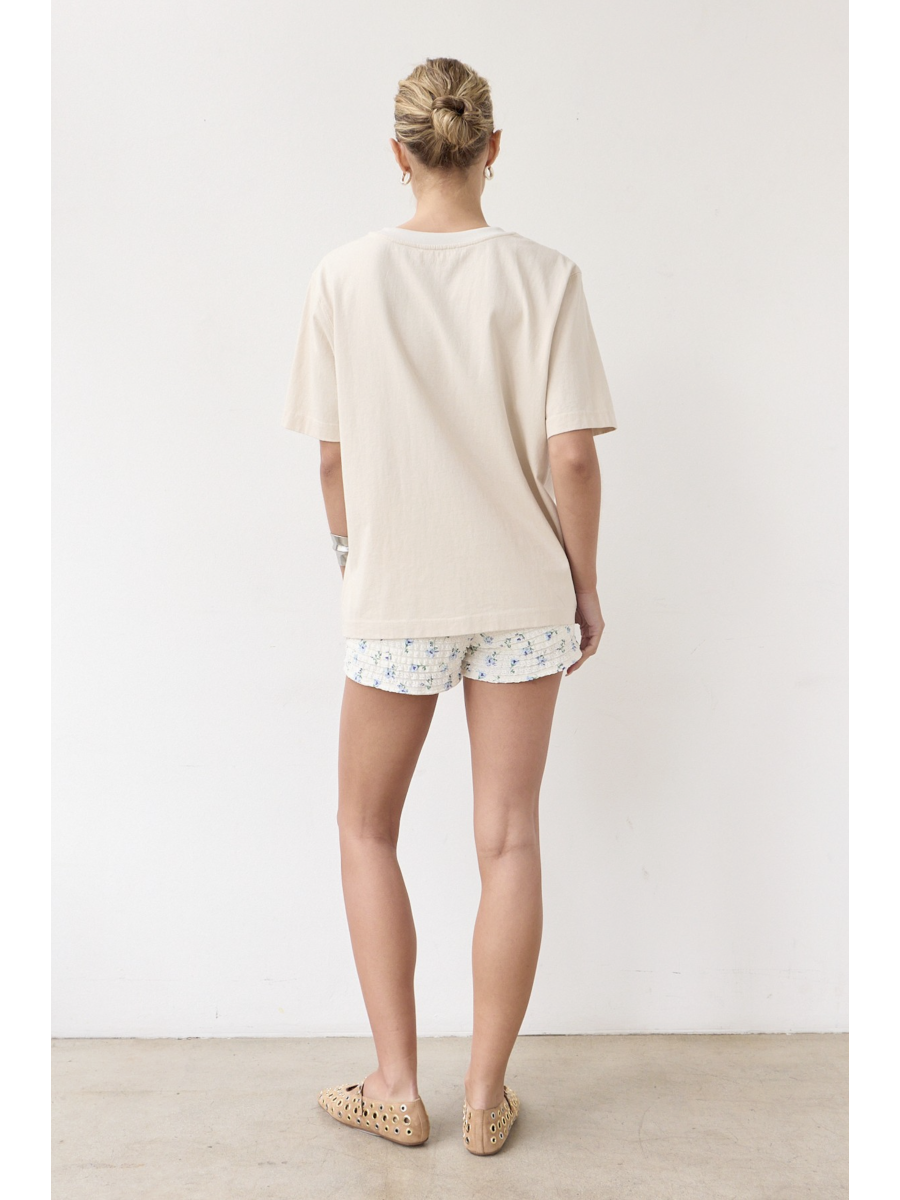 Artisanal t-shirt featuring a whimsical fish graphic with unique stitch details on a soft-wash fabric for a soulful, coastal, slow-living aesthetic