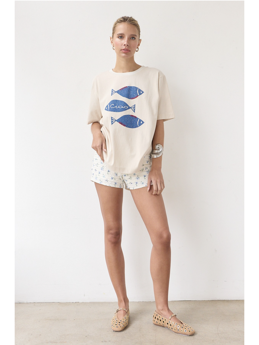 Artisanal t-shirt featuring a whimsical fish graphic with unique stitch details on a soft-wash fabric for a soulful, coastal, slow-living aesthetic