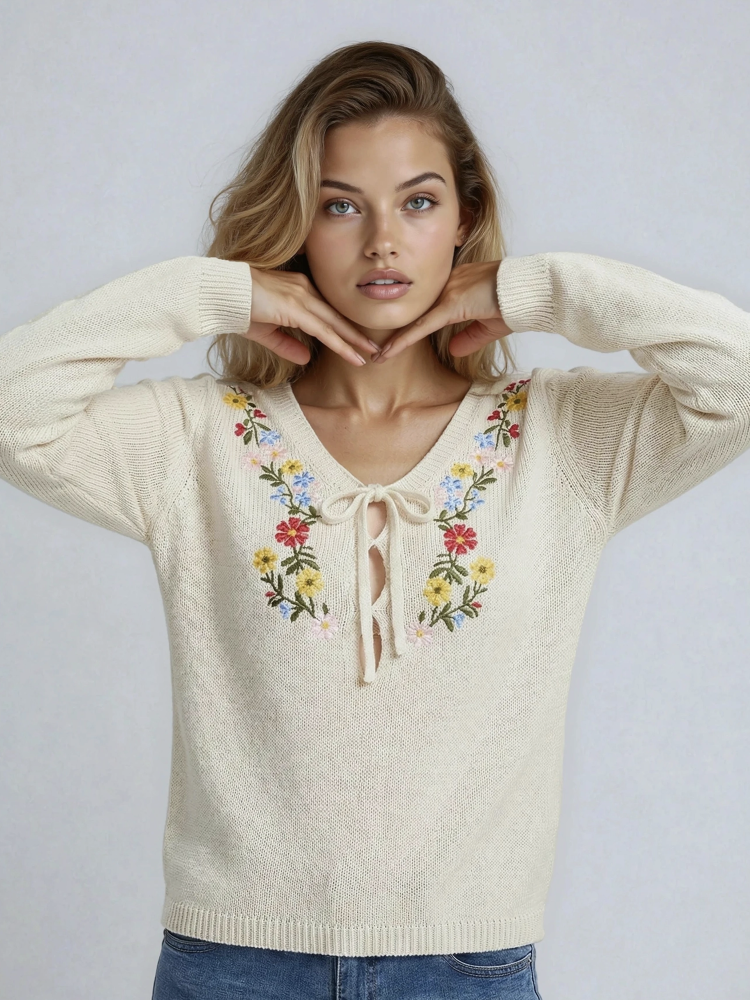 Cozy V-neck sweater featuring delicate colorful floral embroidery on the chest and sleeves for a whimsical, handcrafted look.