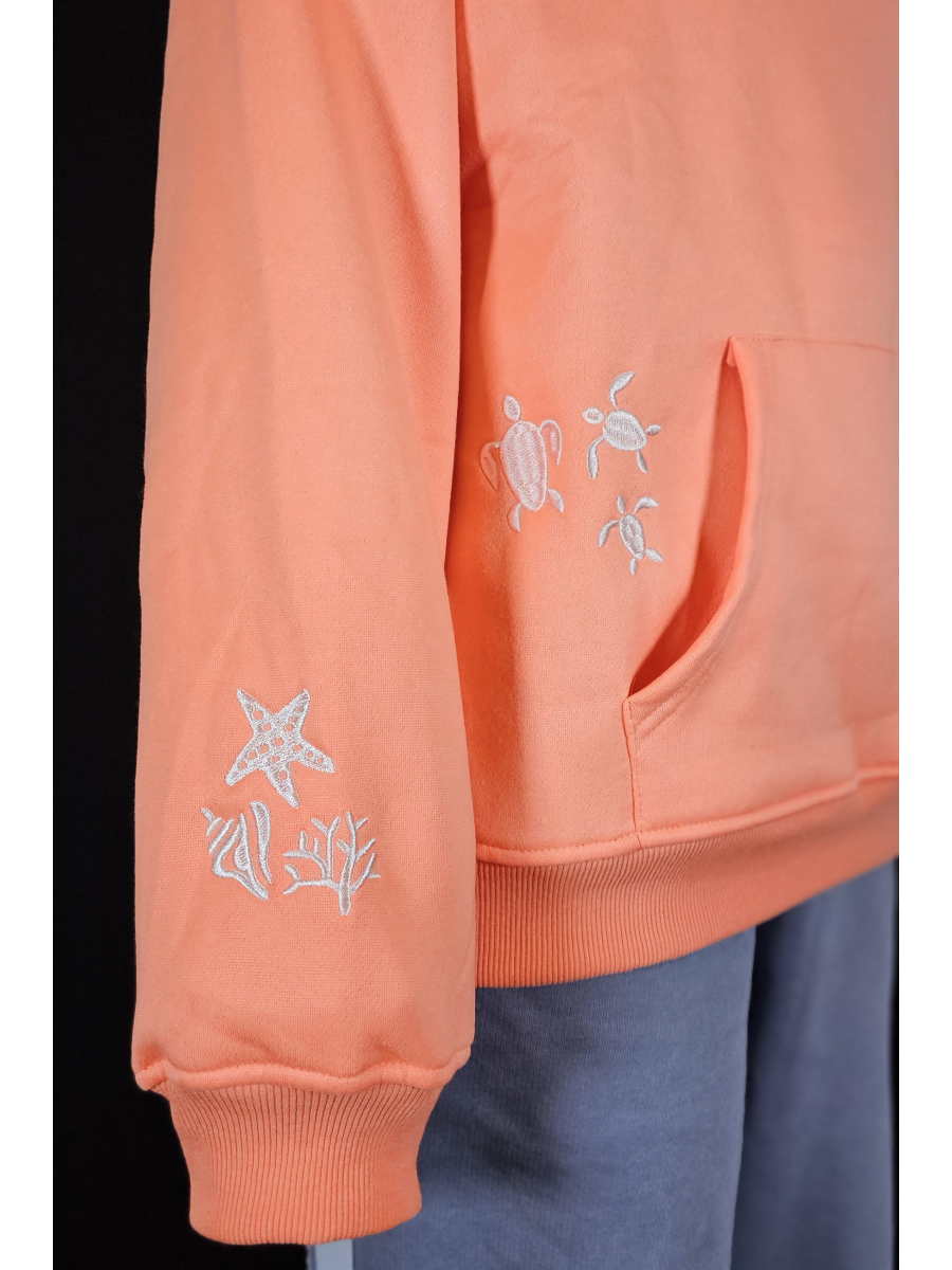 Salmon hoodie with turtle and starfish designs on a black background