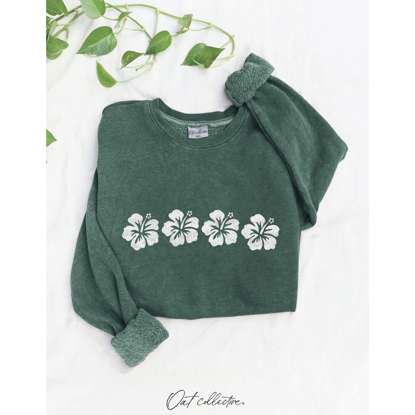 Mineral-wash sweatshirt with a whimsical hibiscus flower row graphic, featuring a soft-brushed texture and a soulful, vintage-inspired coastal look.