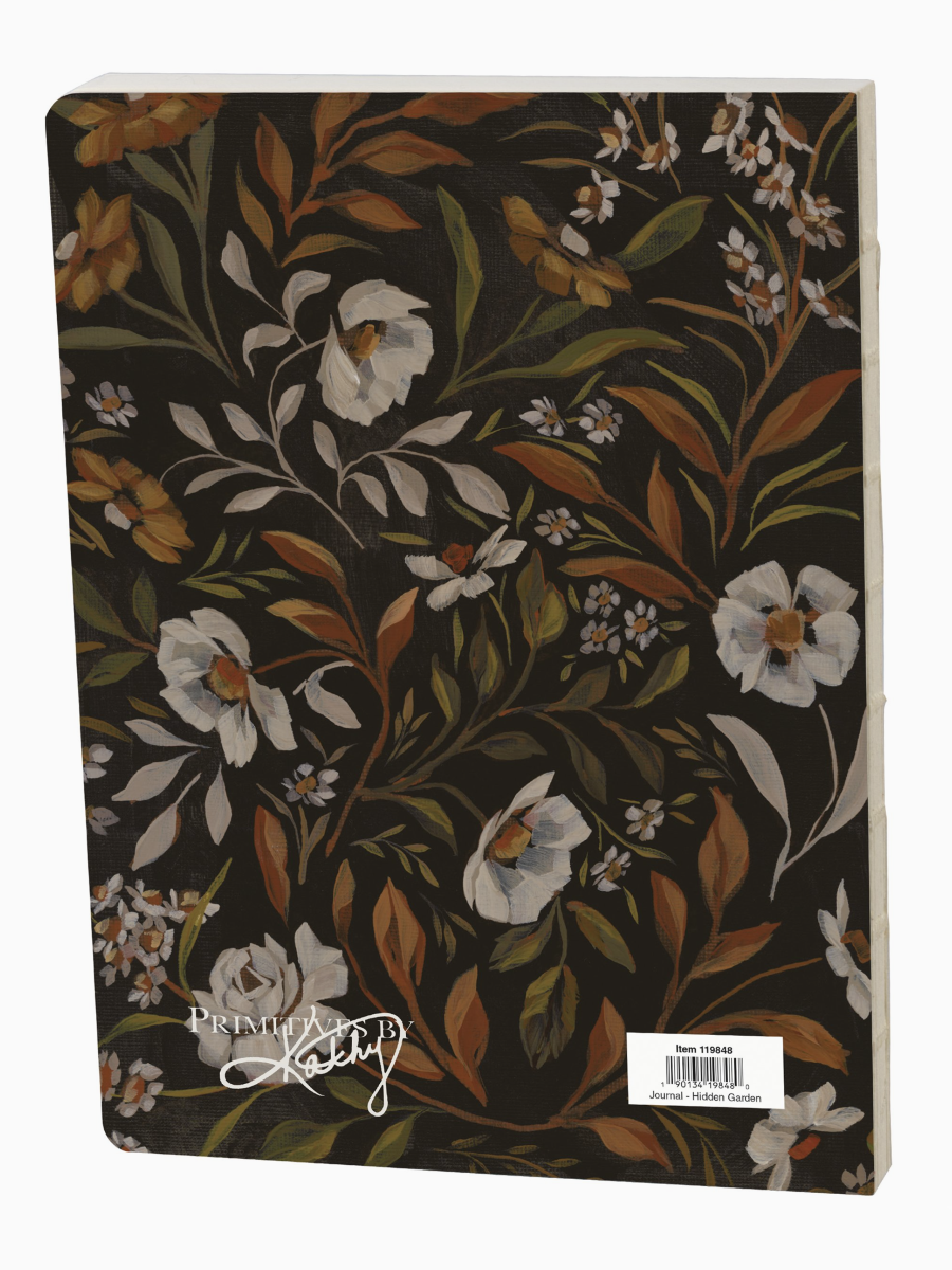 Hidden Garden Journal with dark covers featuring whimsical mushroom and flower illustrations with ferns and small white blooms.