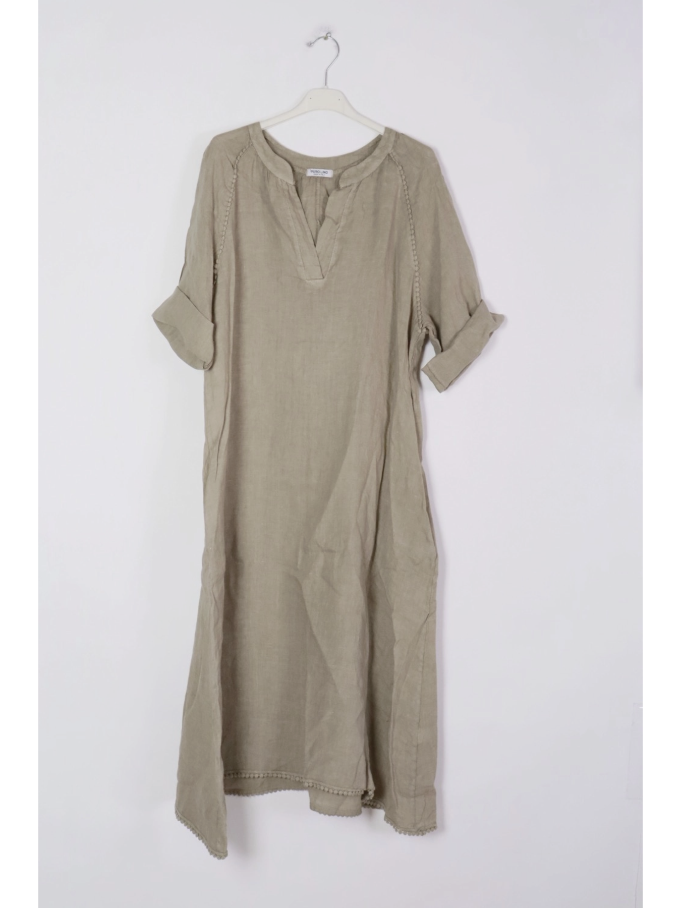 Taupe dress on a hanger against a white background