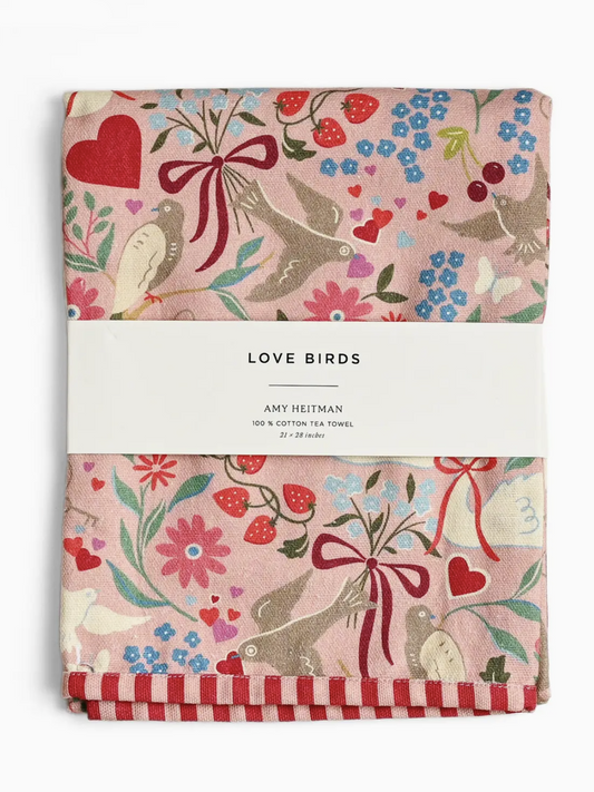 Whimsical watercolor tea towel featuring two small birds perched on a flowering branch with pink blossoms.