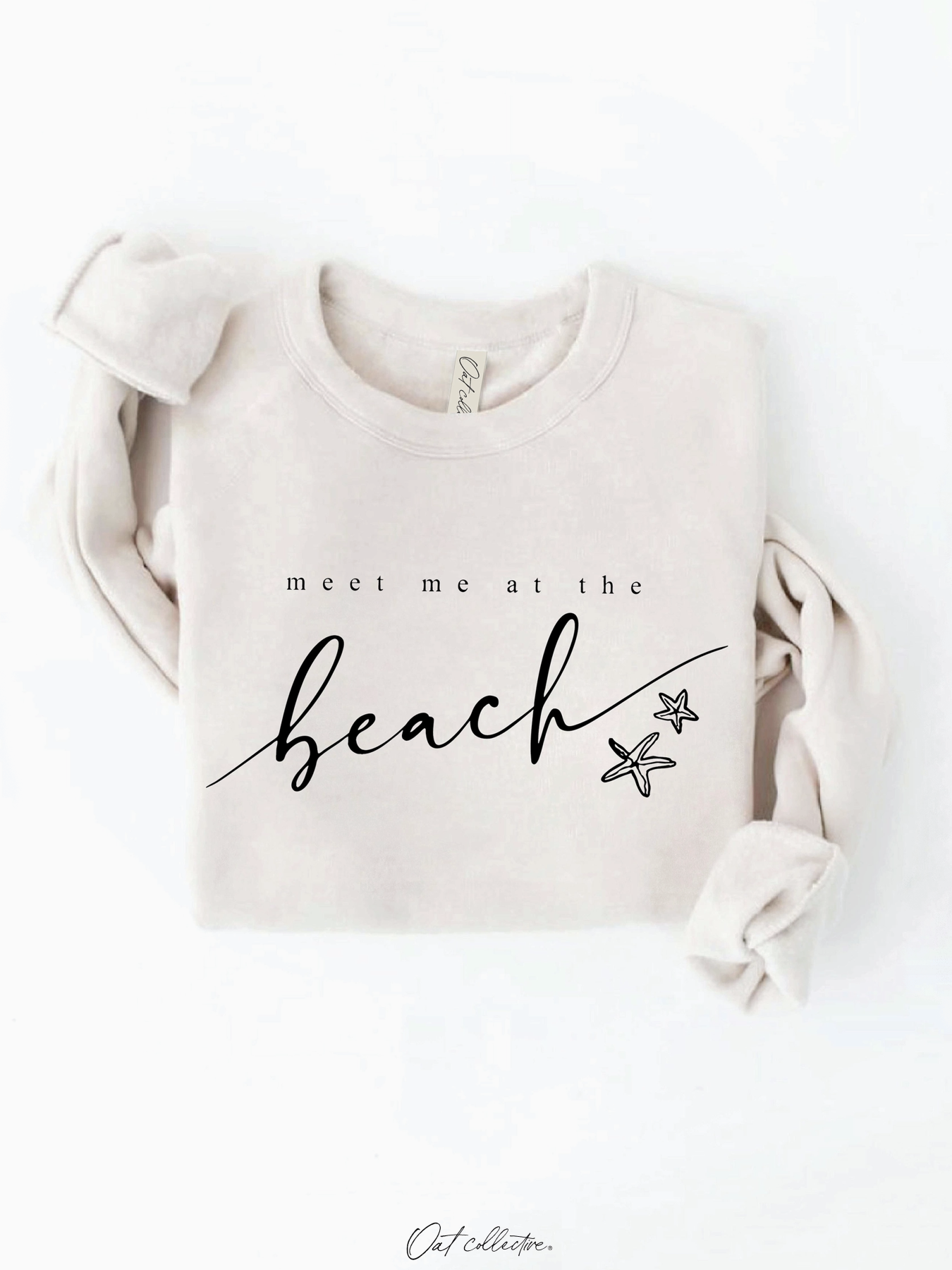 Cozy sweatshirt with a whimsical "Meet Me At the Beach" graphic, featuring a soft-brushed texture and a relaxed, soulful coastal aesthetic.