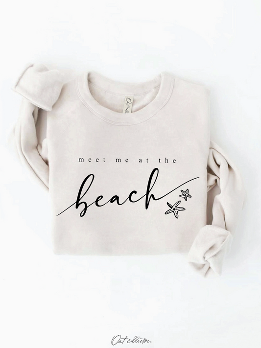 Cozy sweatshirt with a whimsical "Meet Me At the Beach" graphic, featuring a soft-brushed texture and a relaxed, soulful coastal aesthetic.