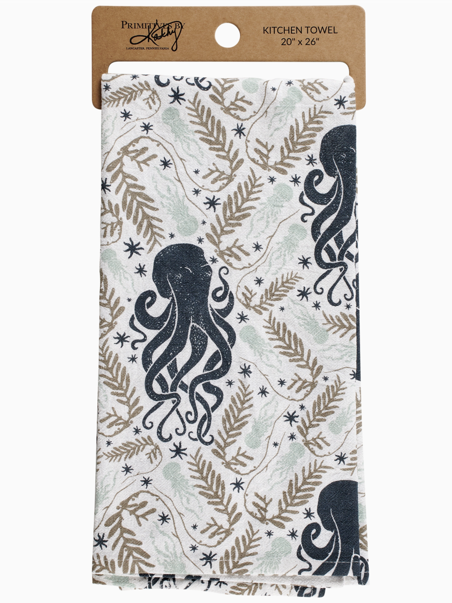 White kitchen towel with a repeating pattern of dark blue octopuses, tan seaweed fronds, and small black stars.