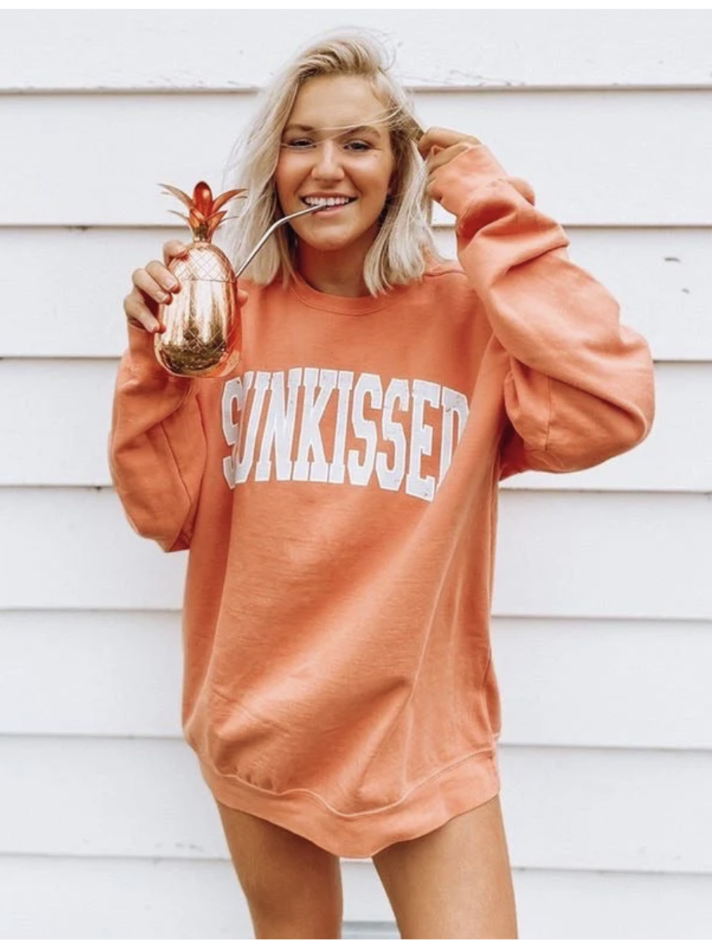 Relaxed-fit sweatshirt featuring a minimalist "Sunkissed" vintage graphic, perfect for a coastal and slow-living aesthetic.