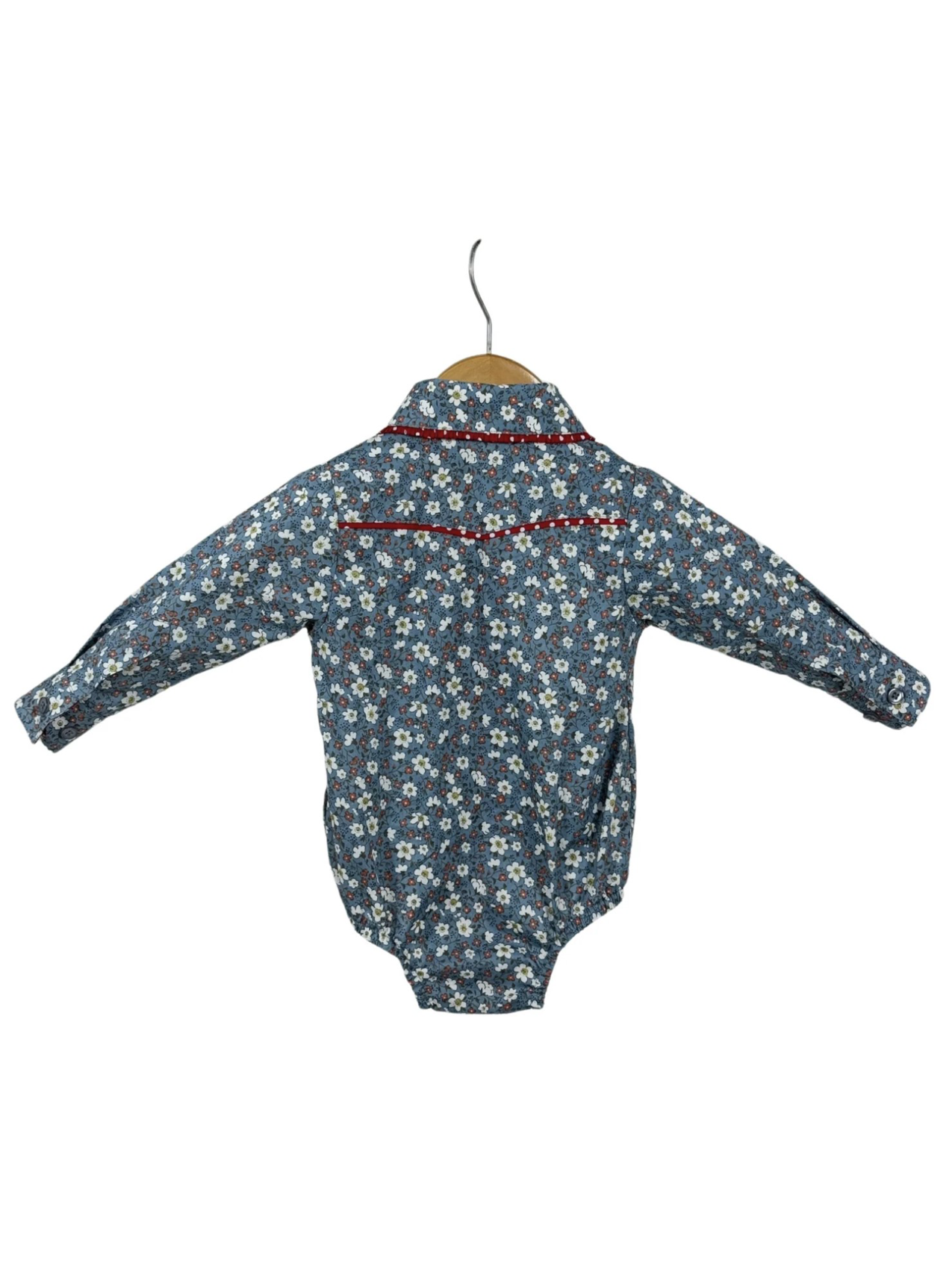 Blue floral baby romper on a hanger against a white background