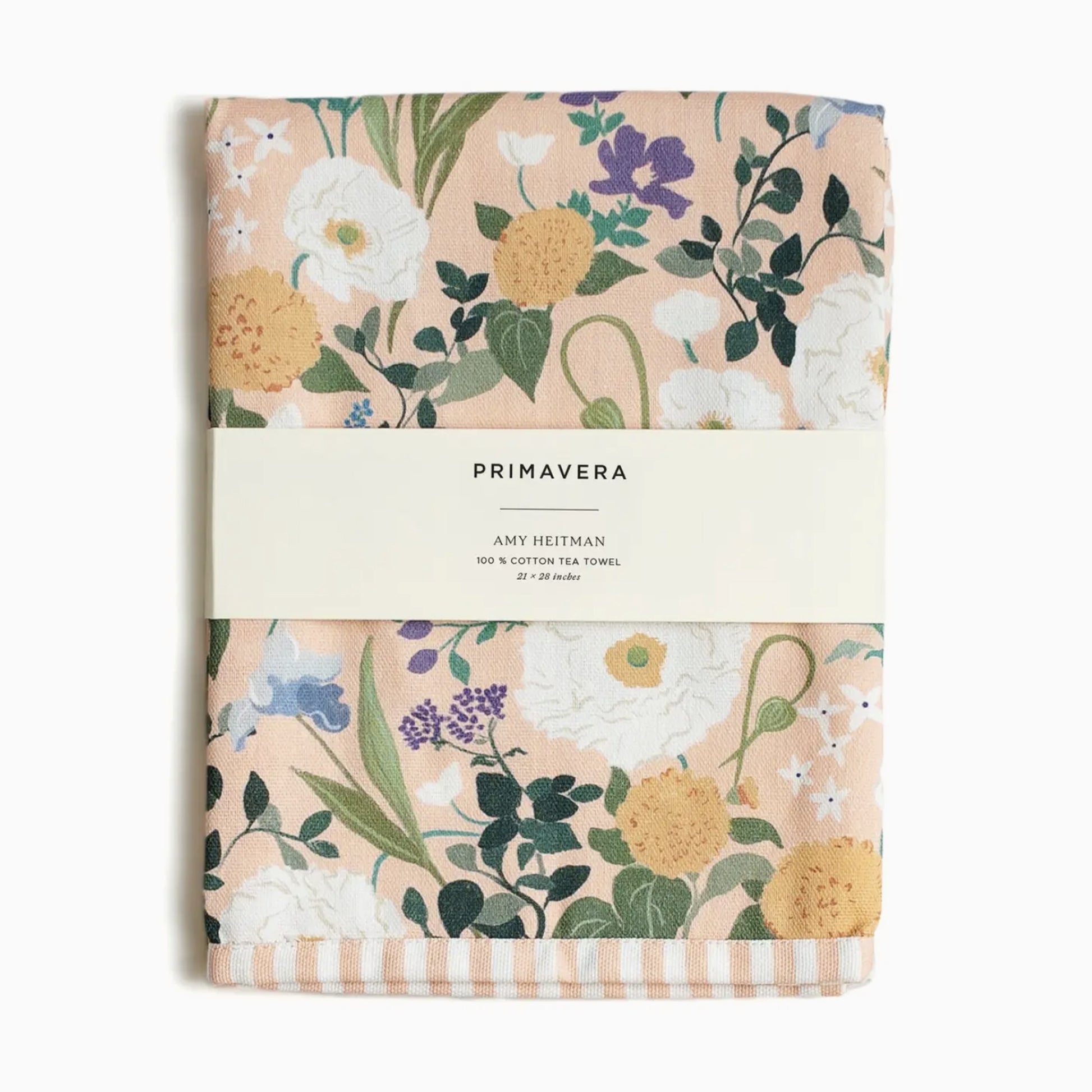 Watercolor floral tea towel with red poppies, yellow daisies, and blue flowers hanging in a bright kitchen.