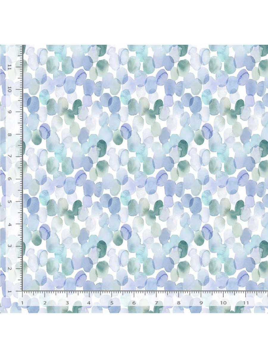 Watercolor fabric pattern featuring translucent, overlapping pebbles in shades of light blue, teal, and soft purple on a white background. Ruler added for reference.