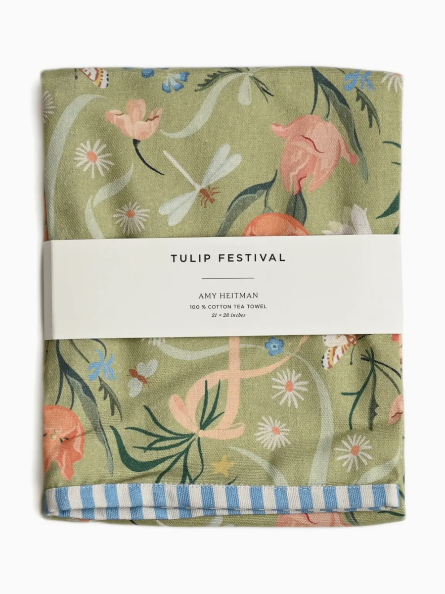 Whimsical watercolor tea towel featuring a vibrant pattern of colorful spring tulips in a painterly meadow style.