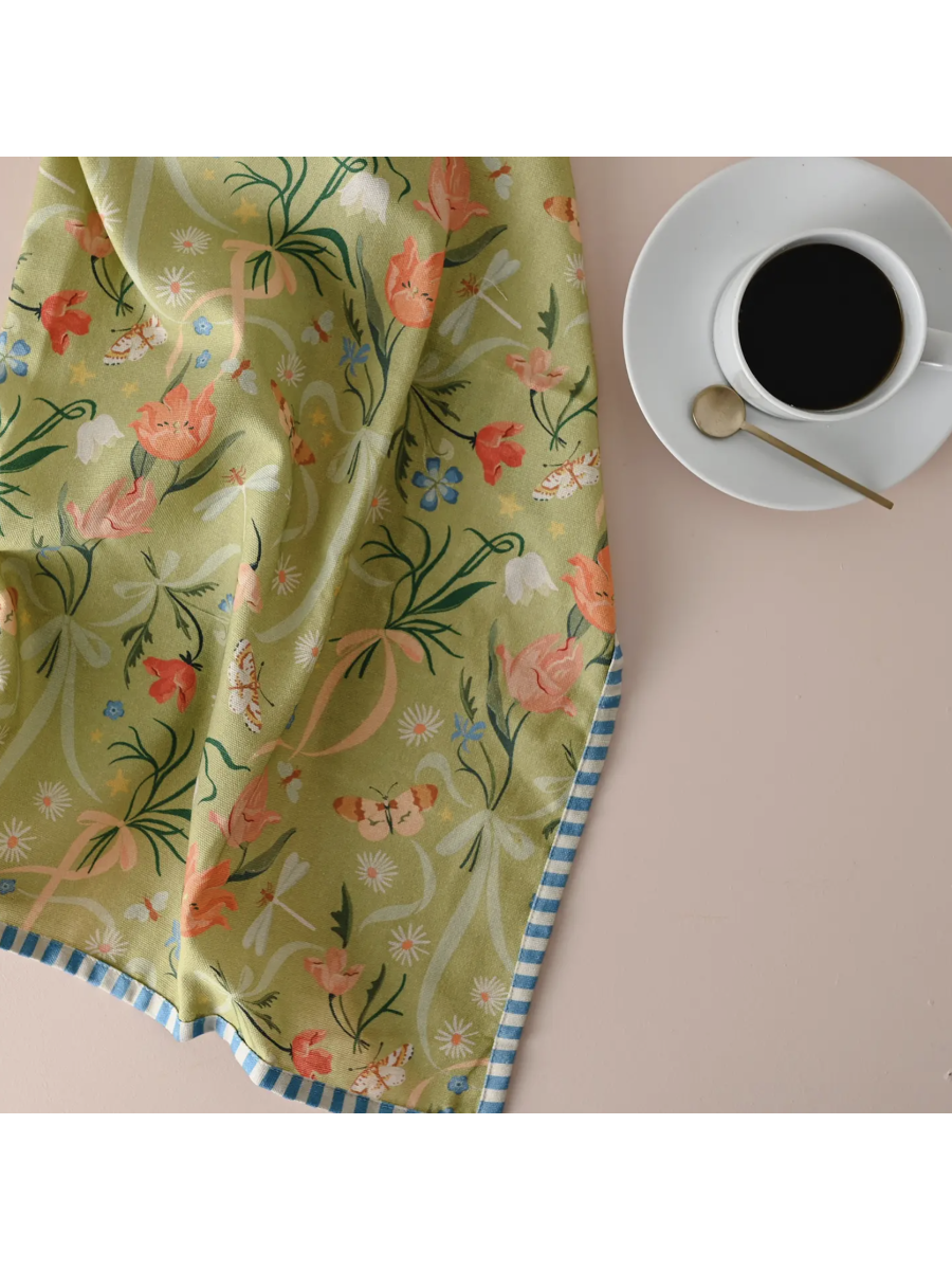 Whimsical watercolor tea towel featuring a vibrant pattern of colorful spring tulips in a painterly meadow style.